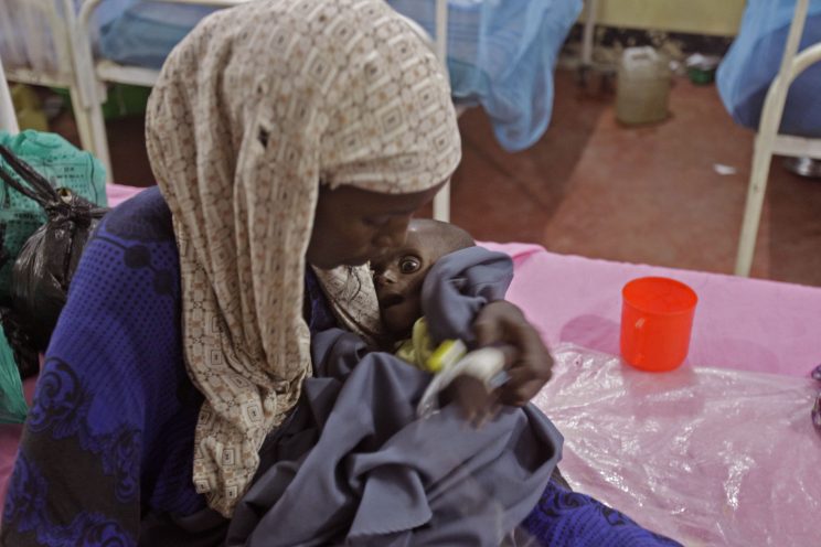 Asiah Dagane holds Mihag Gedi Farah, her seven month old child with a weight of 7 pounds, 8 ounces (3.4 kilograms) at a field hospital of the International Rescue Committee, IRC, in the town of Dadaab, Kenya, Tuesday, July 26, 2011. Mihag Gedi Farah is 7 months old, and weighs as little as a newborn with the weathered skin of an old man. His mother managed to get him to a field hospital in a Kenyan refugee camp after a weeklong odyssey, but the baby's anguished eyes, hollow cheeks and fragile limbs show just how severe Somalia's famine is becoming. (AP Photo/Schalk van Zuydam)